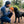 Load image into Gallery viewer, P.L.A.Y. Camp Corbin Cozy Campfire - man crouching down to give toy to black lab in the middle of a forest
