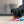 Load image into Gallery viewer, P.L.A.Y. Mini Party Time Collection - Raise the Woof Party Horn Toy on concrete with black wiener dog biting the end
