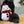 Load image into Gallery viewer, P.L.A.Y. Home for the Holidays Collection Blizzard Buddy - toy between the front paws of a black Poodle laying down on a woven rug
